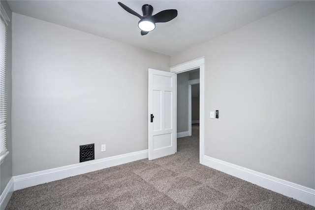 carpeted spare room featuring ceiling fan