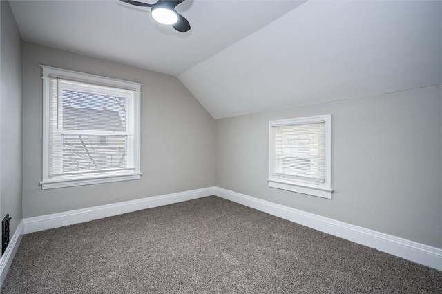 bonus room featuring lofted ceiling, a healthy amount of sunlight, ceiling fan, and carpet floors