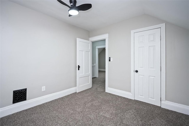 unfurnished bedroom featuring ceiling fan, carpet, a closet, and lofted ceiling