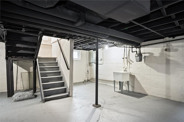 basement featuring sink and electric panel