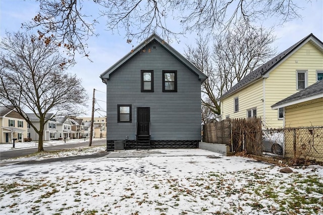 view of snow covered rear of property