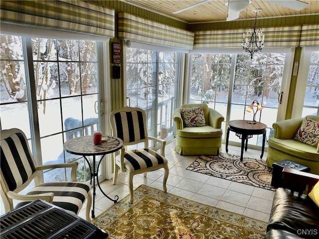 sunroom / solarium featuring wood ceiling, a wealth of natural light, and ceiling fan