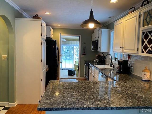 kitchen with sink, white cabinetry, black appliances, kitchen peninsula, and backsplash