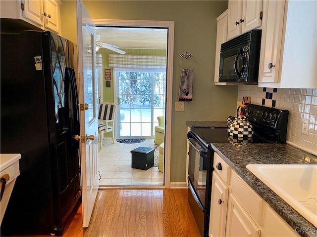 kitchen featuring black appliances, light wood-type flooring, ceiling fan, decorative backsplash, and white cabinets