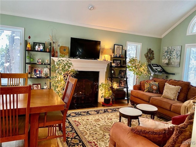 living room with vaulted ceiling, plenty of natural light, and crown molding