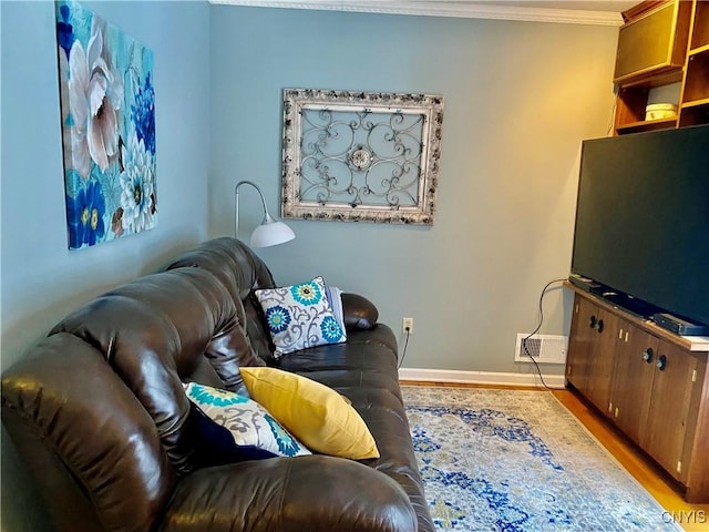 living room with ornamental molding and wood-type flooring