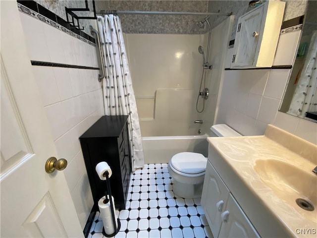 full bathroom with tasteful backsplash, tile walls, vanity, toilet, and shower / bath combo