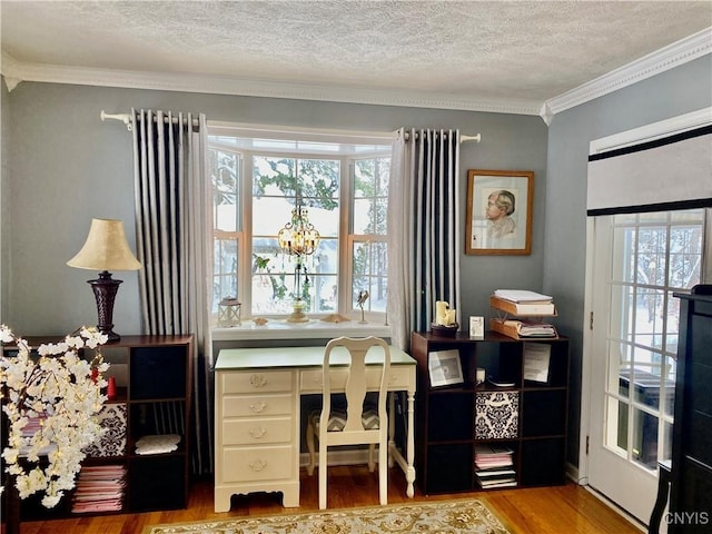 office area featuring ornamental molding, hardwood / wood-style floors, a textured ceiling, and plenty of natural light