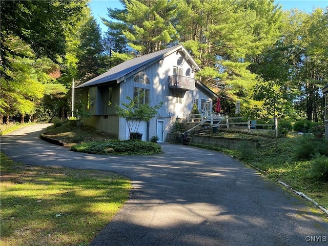 view of side of home featuring a balcony