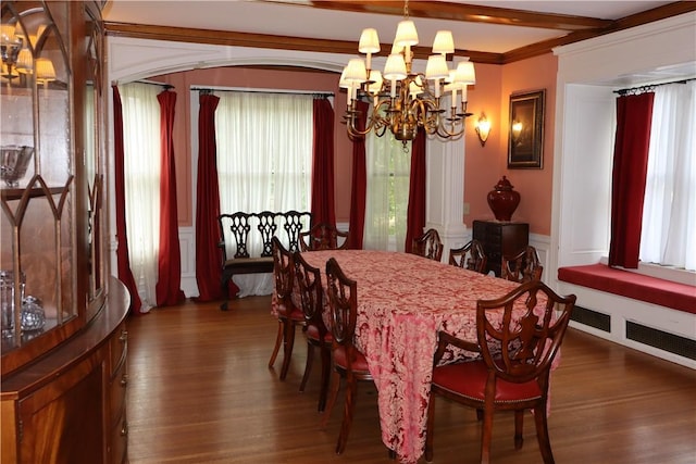 dining area with dark hardwood / wood-style floors, beamed ceiling, and an inviting chandelier