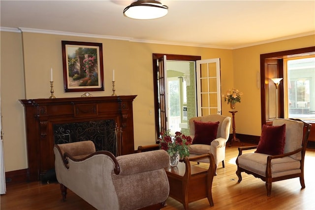 sitting room featuring crown molding and hardwood / wood-style floors