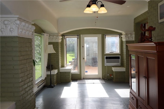 doorway with ceiling fan, a baseboard heating unit, and a wall unit AC