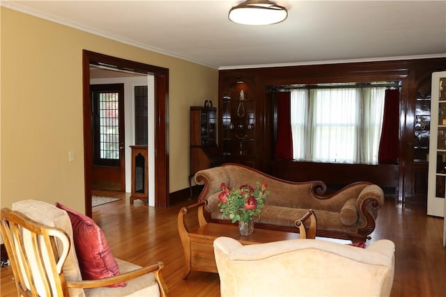 living room with hardwood / wood-style floors and ornamental molding