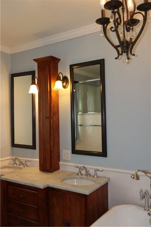 bathroom featuring vanity, crown molding, and a bath