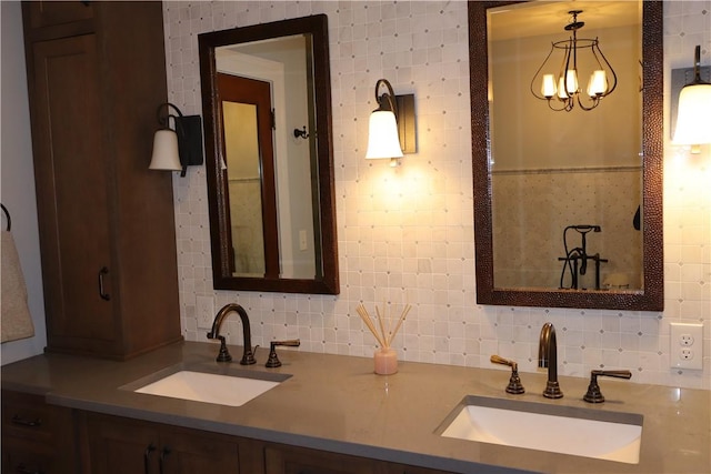 bathroom featuring decorative backsplash, vanity, and a notable chandelier