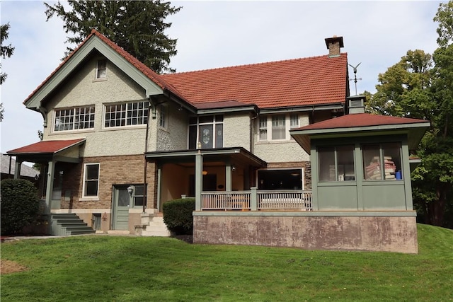 rear view of property with a lawn