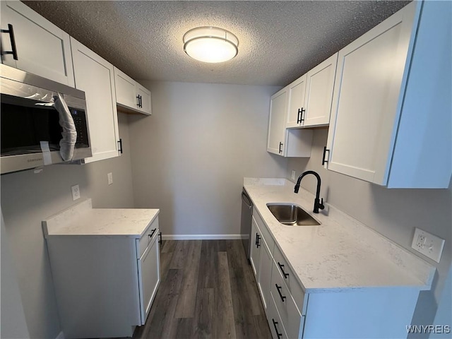 kitchen featuring dishwasher, white cabinets, dark hardwood / wood-style flooring, and sink