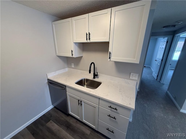 kitchen featuring sink, black dishwasher, white cabinetry, a textured ceiling, and dark hardwood / wood-style flooring