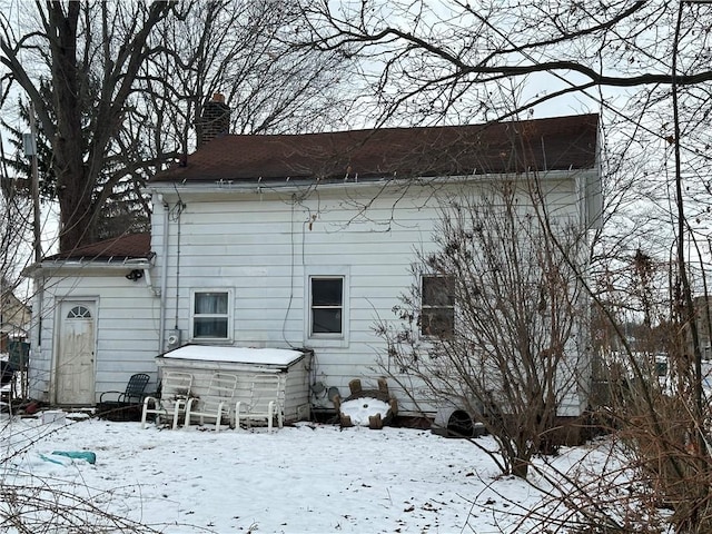 view of snow covered rear of property