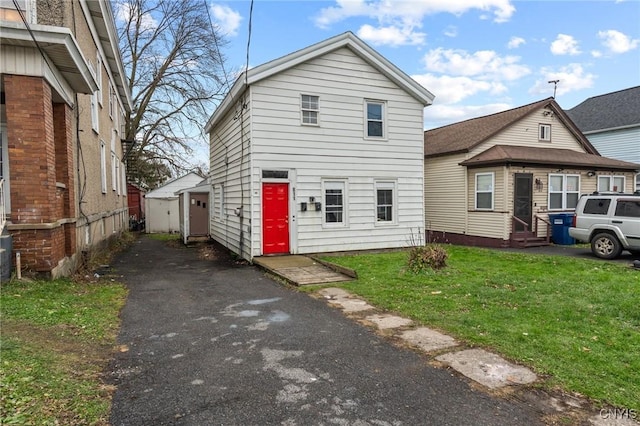 view of property featuring a front lawn