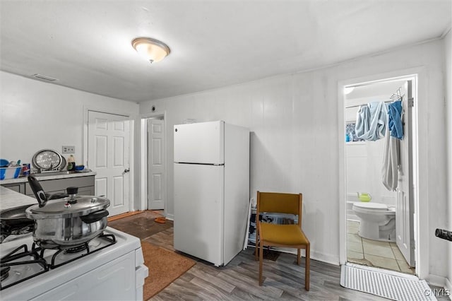 kitchen with hardwood / wood-style floors and white appliances