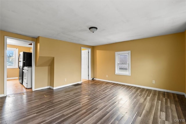 empty room with dark hardwood / wood-style flooring