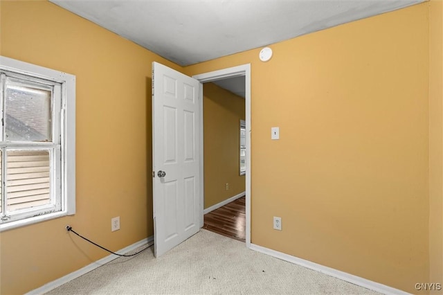 empty room featuring light colored carpet