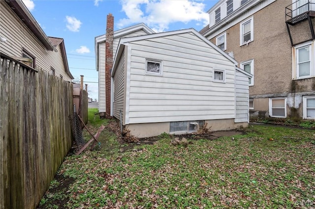 view of side of home featuring a lawn