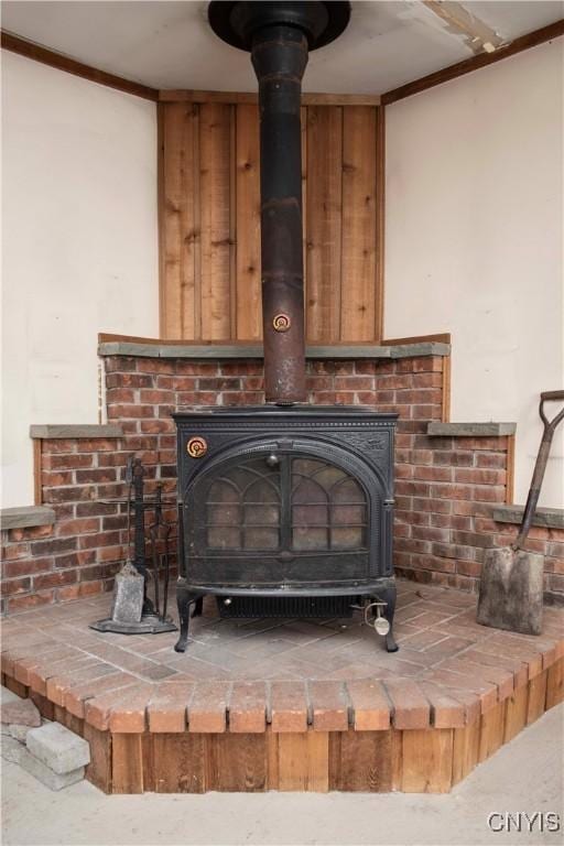 interior details featuring a wood stove and crown molding