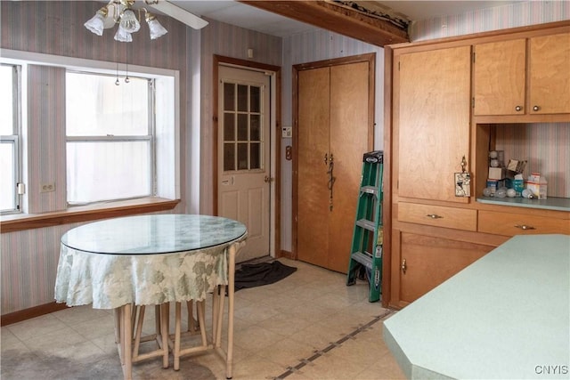 dining room featuring ceiling fan and wood walls