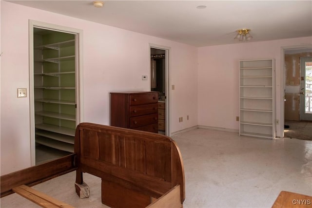 bedroom with a walk in closet and a closet