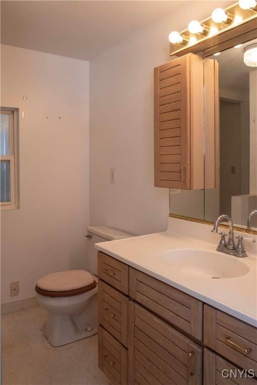 bathroom featuring toilet, vanity, and tile patterned floors