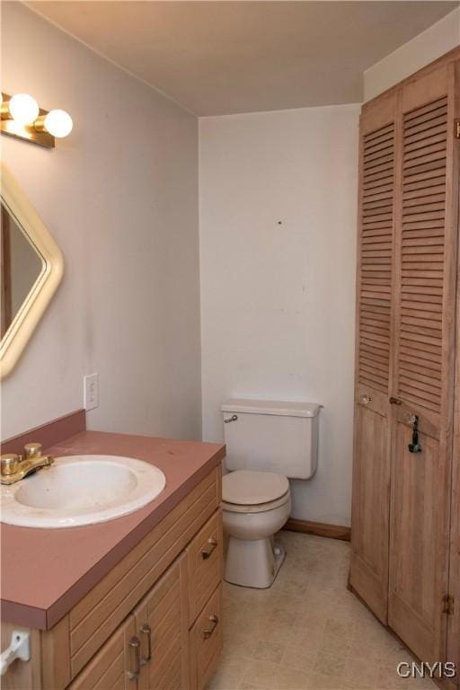 bathroom with toilet and vanity