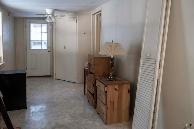 doorway with ceiling fan