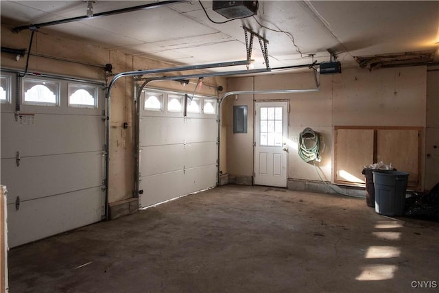 garage featuring electric panel and a garage door opener