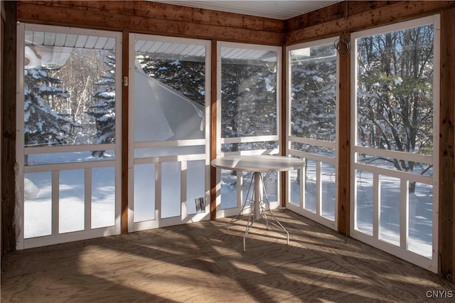 unfurnished sunroom with plenty of natural light