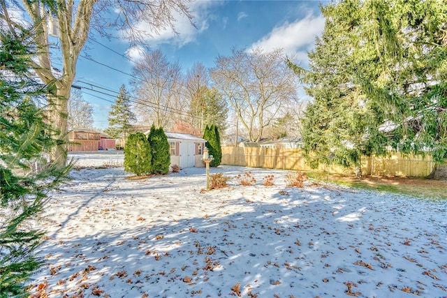 snowy yard featuring an outbuilding