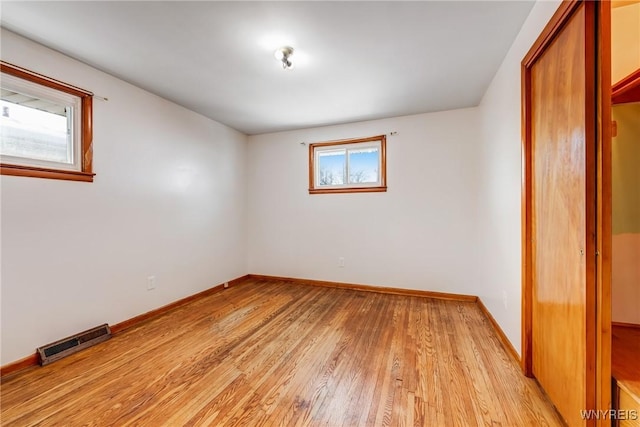 unfurnished bedroom with a closet and light hardwood / wood-style flooring