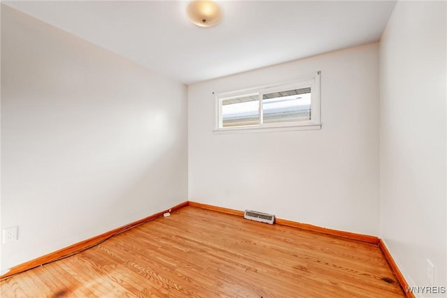 empty room with hardwood / wood-style floors