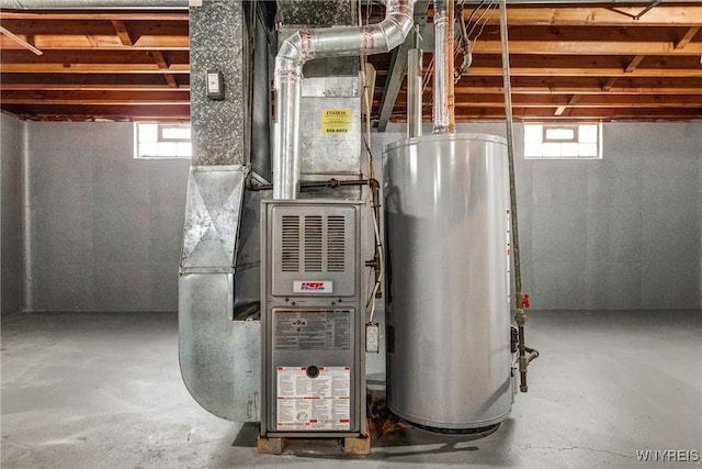 utility room featuring heating unit and gas water heater