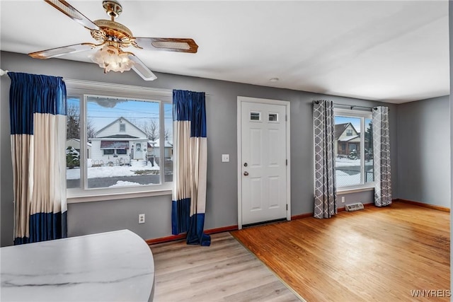 entrance foyer with ceiling fan and light hardwood / wood-style flooring