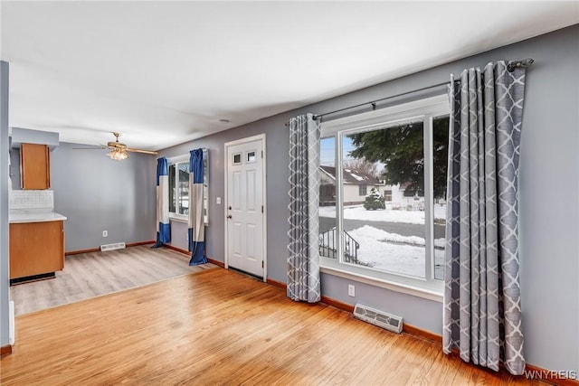 entryway with ceiling fan, light hardwood / wood-style flooring, and plenty of natural light