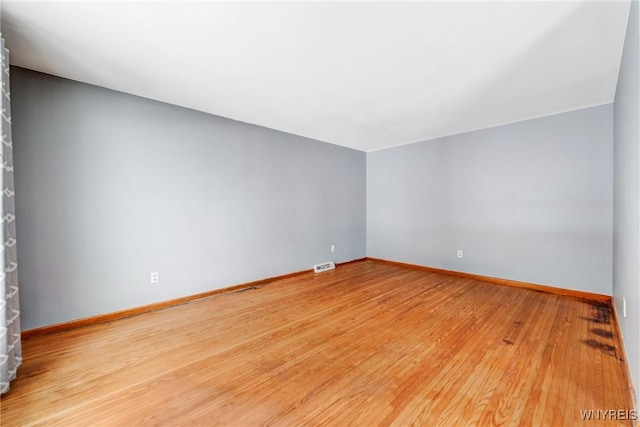 unfurnished room with light hardwood / wood-style floors