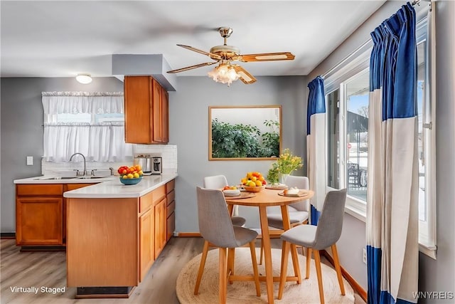 kitchen with a healthy amount of sunlight, light hardwood / wood-style floors, and sink