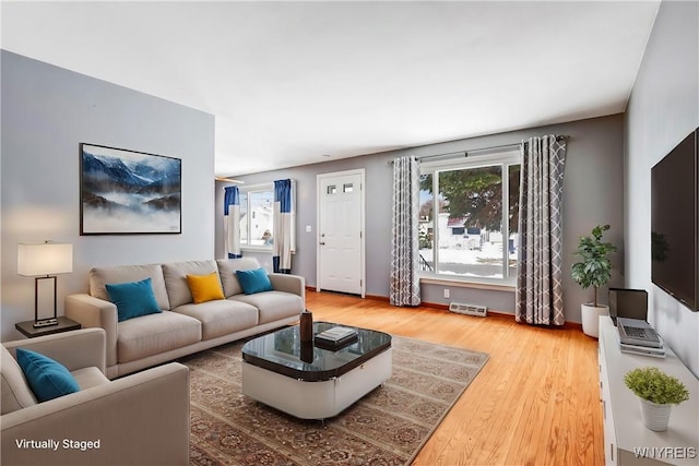 living room featuring a wealth of natural light and wood-type flooring