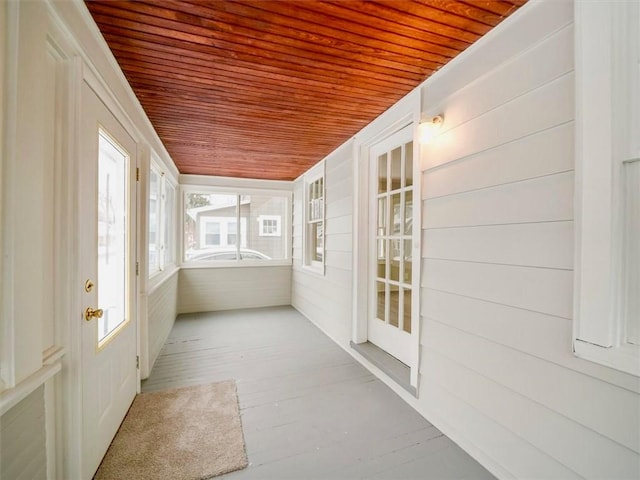 unfurnished sunroom with wood ceiling