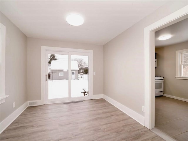 empty room with light hardwood / wood-style floors