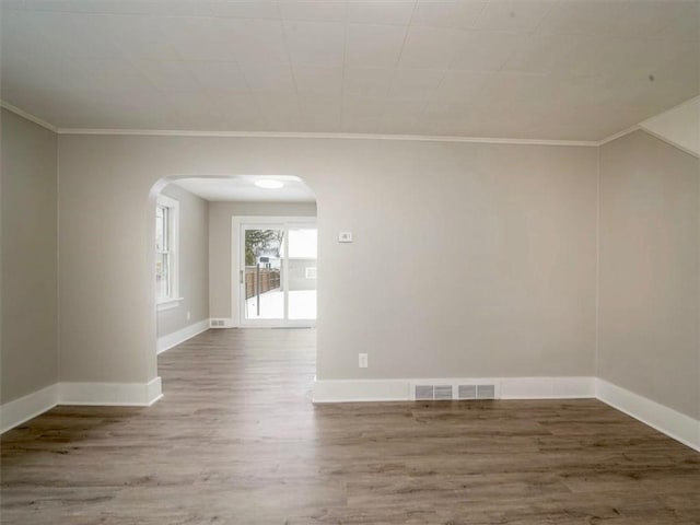 unfurnished room with wood-type flooring and ornamental molding