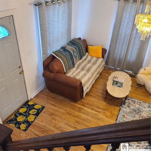 foyer entrance with a chandelier and hardwood / wood-style floors