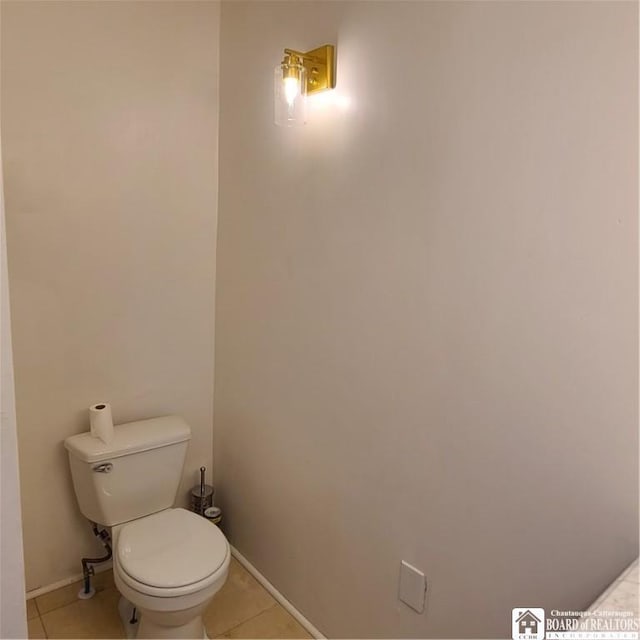 bathroom with toilet and tile patterned floors